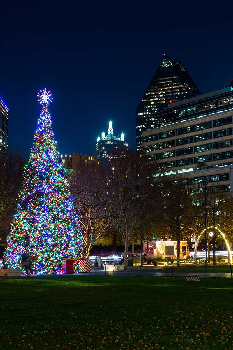 Christmas tree in the Klyde Warren Park in downtown surrounded by high-rise buildings Christmas tree in the Klyde Warren Park in downtown surrounded by high-rise buildings
